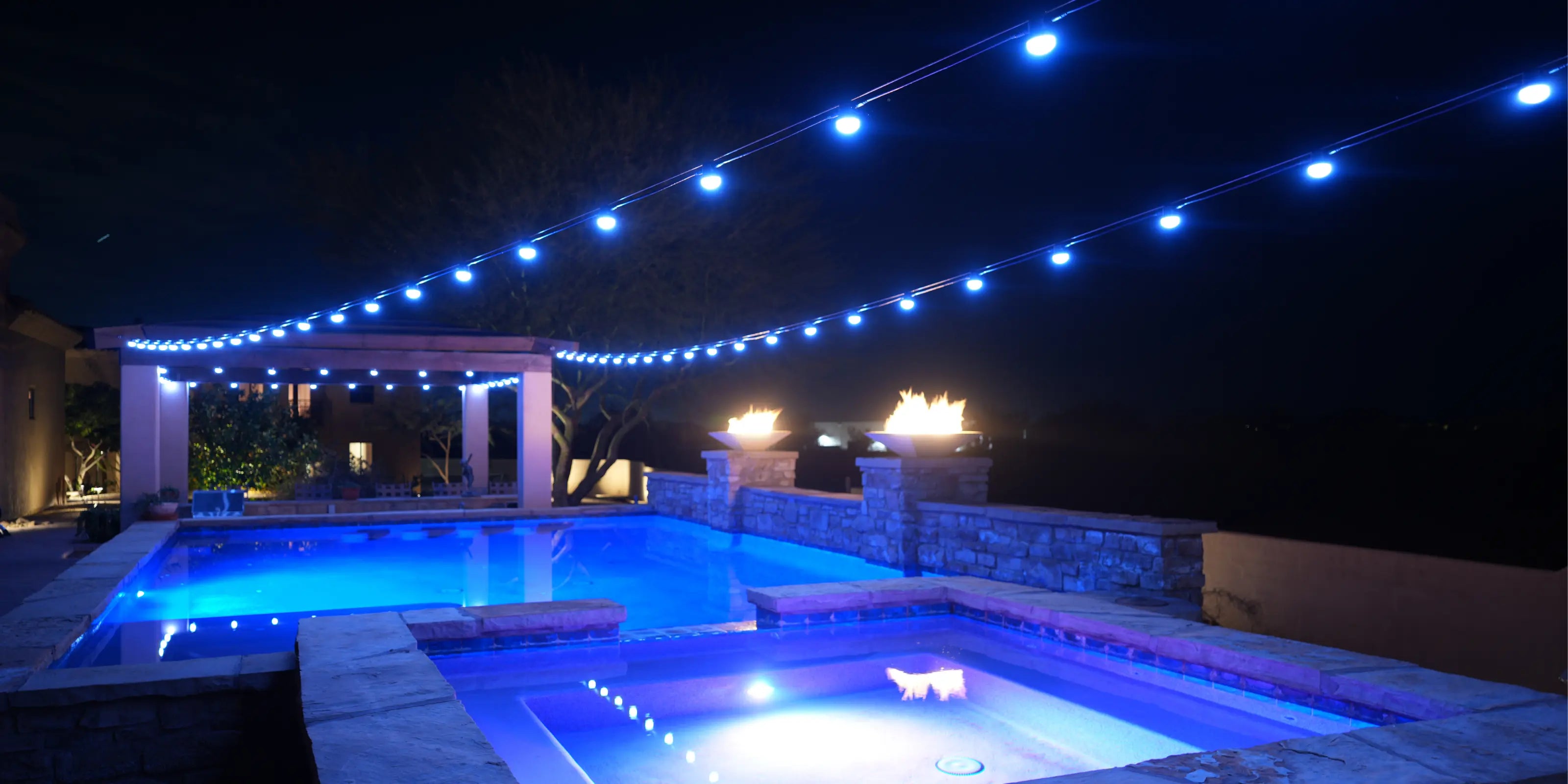 Pool area with string lights at night